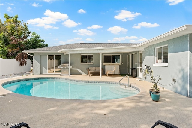 view of swimming pool with area for grilling and a patio