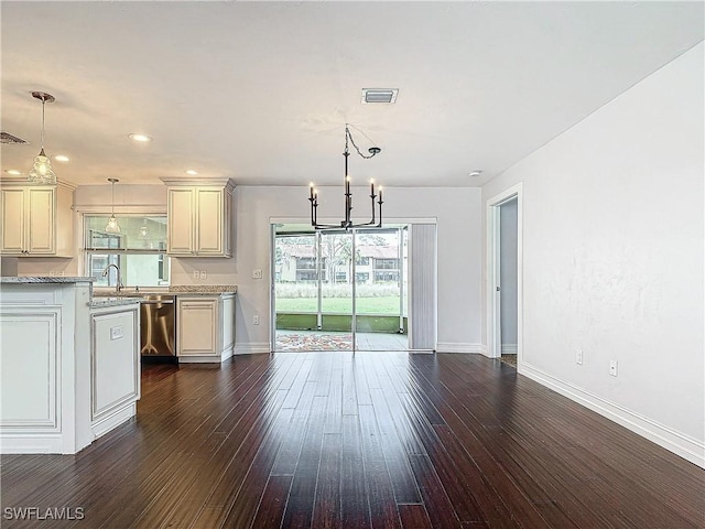 4348 Beechwood Lake Dr, Naples, FL 34112 - kitchen featuring hanging light fixtures, dark wood-type flooring, stainless steel dishwasher, and light stone counters