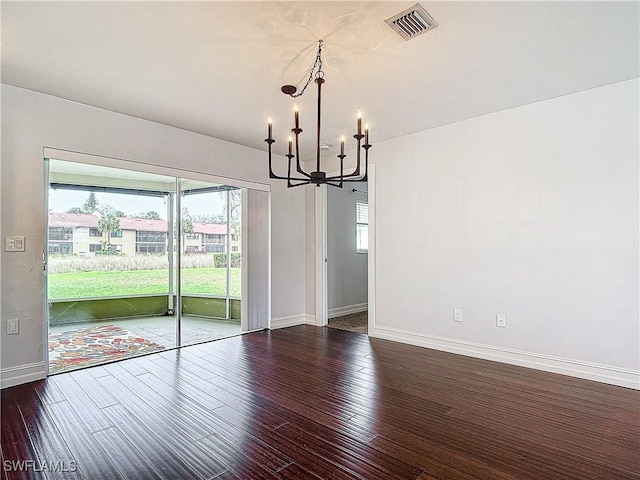 4348 Beechwood Lake Dr, Naples, FL 34112 - unfurnished dining area with an inviting chandelier and hardwood / wood-style floors