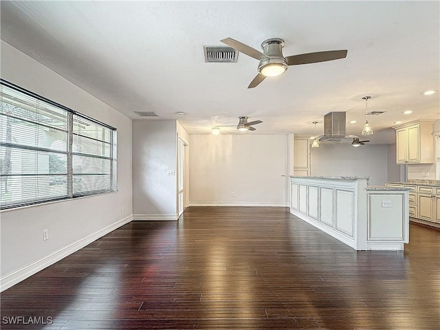 unfurnished living room featuring dark hardwood / wood-style floors and ceiling fan