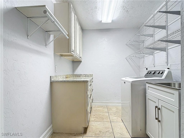 4348 Beechwood Lake Dr, Naples, FL 34112 - laundry area with separate washer and dryer, cabinets, a textured ceiling, and light tile patterned flooring