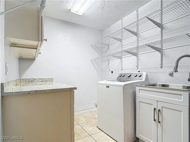 4348 Beechwood Lake Dr, Naples, FL 34112 - washroom featuring light tile patterned floors, sink, cabinets, a textured ceiling, and washer / clothes dryer