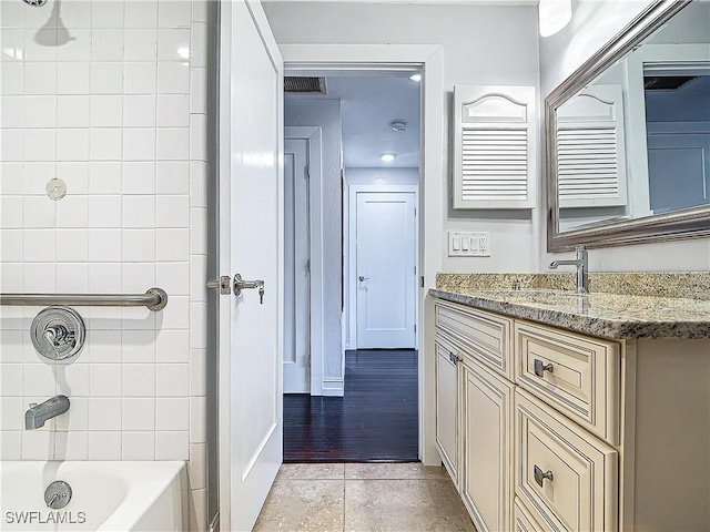 4348 Beechwood Lake Dr, Naples, FL 34112 - bathroom featuring tiled shower / bath combo, vanity, and tile patterned flooring