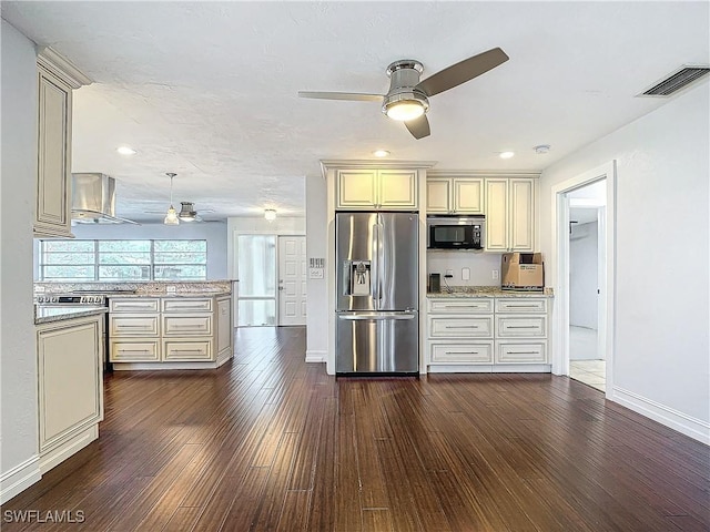 4348 Beechwood Lake Dr, Naples, FL 34112 - kitchen featuring appliances with stainless steel finishes, dark wood-type flooring, cream cabinets, and wall chimney exhaust hood