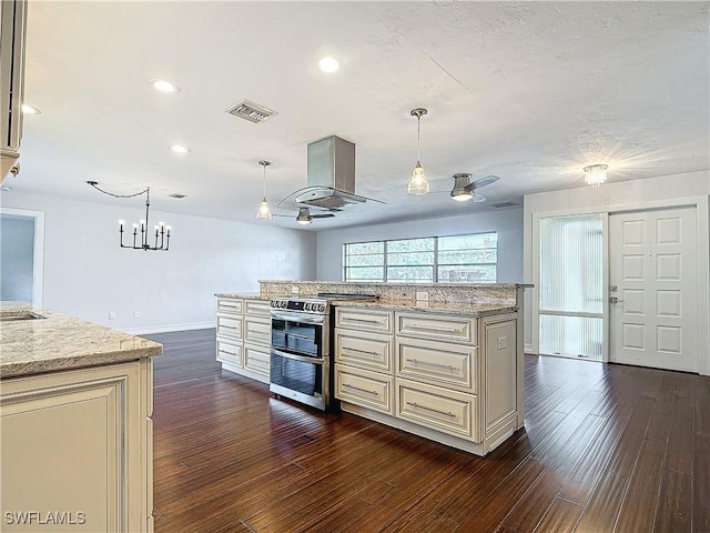 4348 Beechwood Lake Dr, Naples, FL 34112 - kitchen featuring double oven range, hanging light fixtures, cream cabinetry, and island exhaust hood