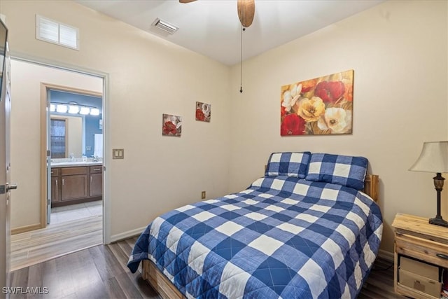 bedroom with ensuite bathroom, ceiling fan, and dark hardwood / wood-style flooring