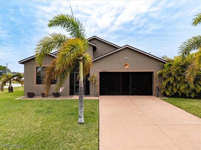 3014 SW 9th Pl, Cape Coral, FL 33914 - view of front of home featuring stucco siding, an attached garage, driveway, and a front lawn