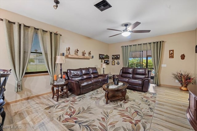 living room featuring light wood-type flooring and ceiling fan