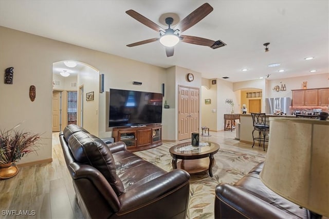 living room featuring light hardwood / wood-style floors and ceiling fan