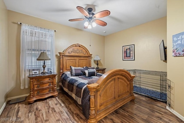 bedroom featuring ceiling fan and dark hardwood / wood-style floors