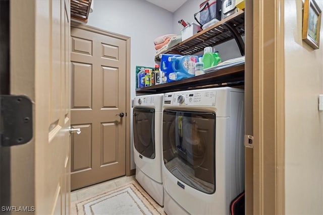 washroom with washing machine and clothes dryer