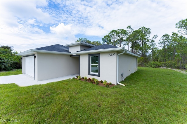 view of home's exterior featuring a yard and a garage