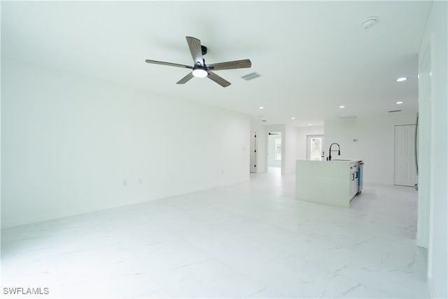 empty room featuring ceiling fan and sink