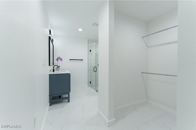 bathroom with walk in shower and vanity