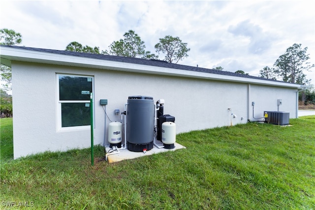 view of property exterior featuring a lawn and central AC