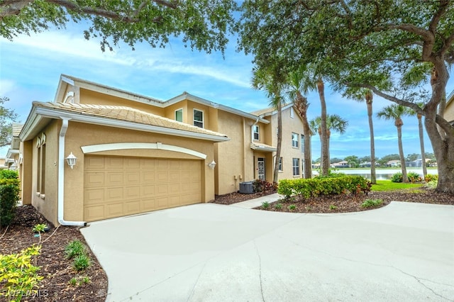 view of front of home featuring central AC unit and a garage