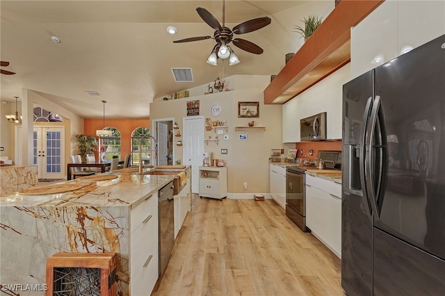 kitchen featuring french doors, stainless steel appliances, pendant lighting, and white cabinetry