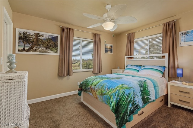 bedroom featuring ceiling fan and dark carpet