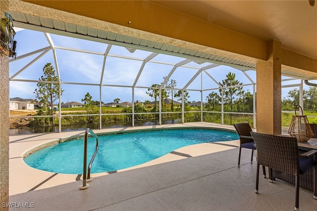 view of swimming pool with a patio area and a lanai