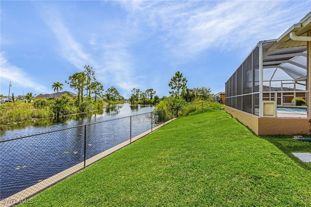 view of yard featuring a lanai and a water view