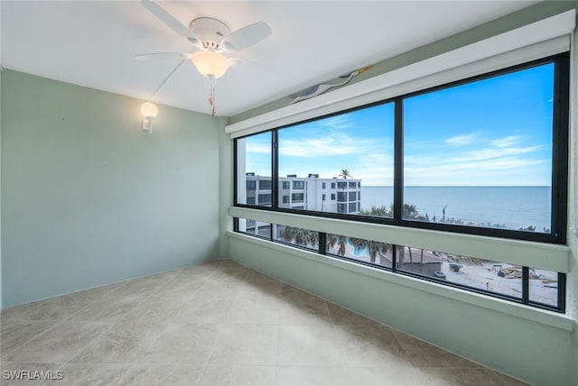 interior space featuring ceiling fan and a water view