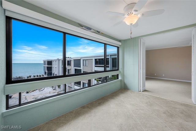 2777 W Gulf Dr Unit 309, Sanibel, FL 33957 - sunroom / solarium with a ceiling fan and a water view
