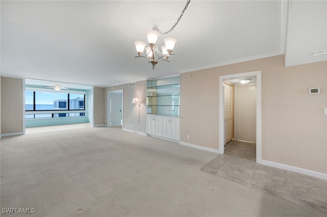 unfurnished living room featuring light carpet, an inviting chandelier, and crown molding