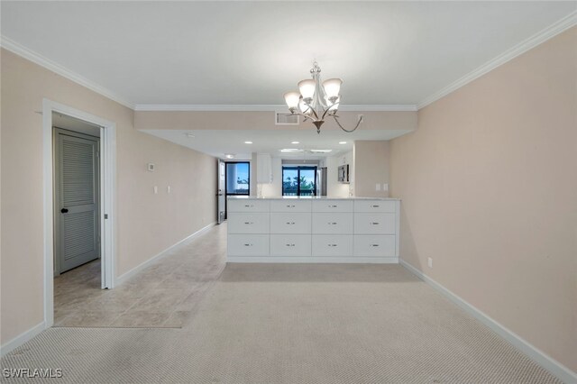 unfurnished dining area featuring light carpet, crown molding, and a chandelier