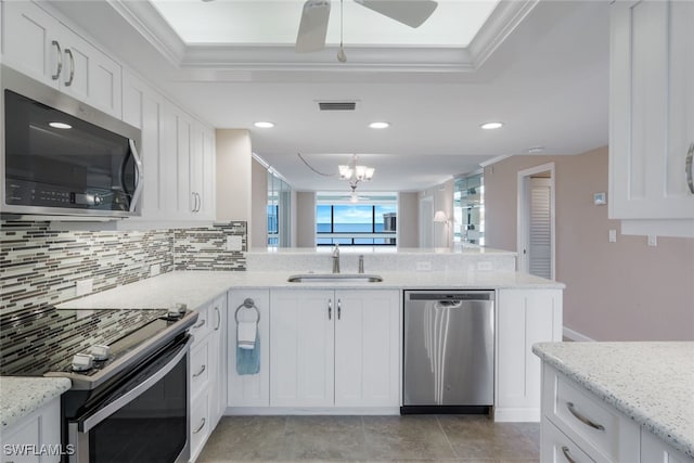 kitchen with tasteful backsplash, sink, light stone countertops, stainless steel appliances, and white cabinets