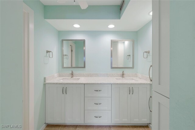 bathroom with ceiling fan, tile patterned floors, and vanity