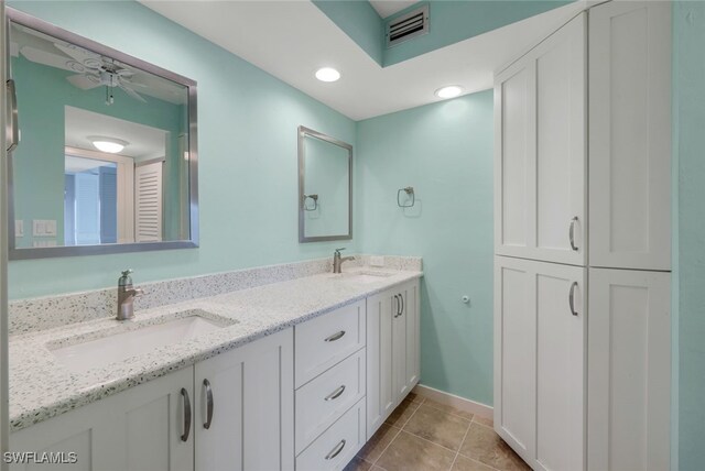 bathroom with ceiling fan, tile patterned floors, and vanity