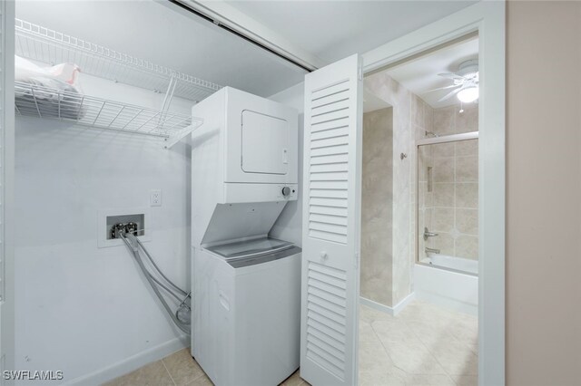 clothes washing area with ceiling fan and stacked washer and dryer