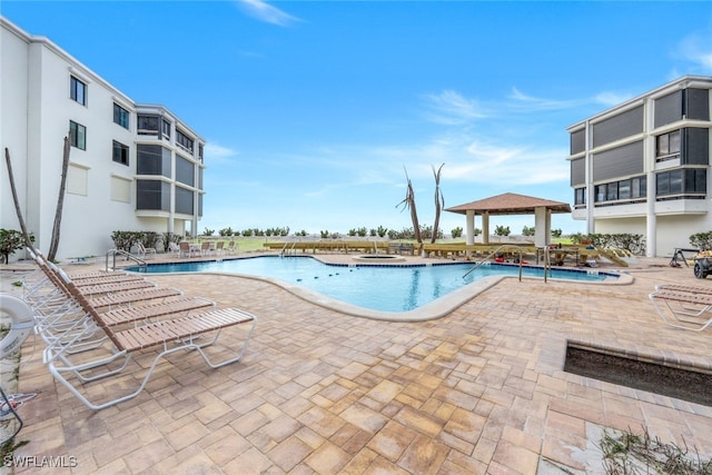 view of pool with a gazebo, a patio, and a community hot tub