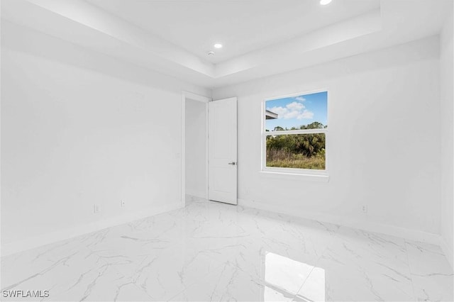 empty room featuring a tray ceiling