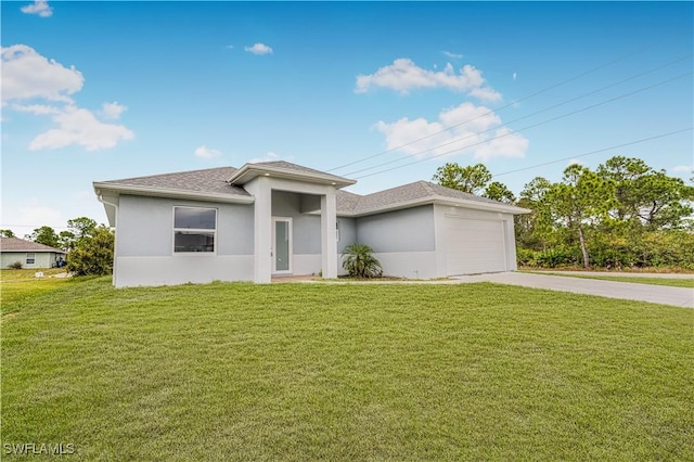 view of front of house featuring a front yard and a garage