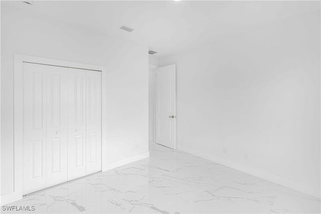 unfurnished bedroom with a closet