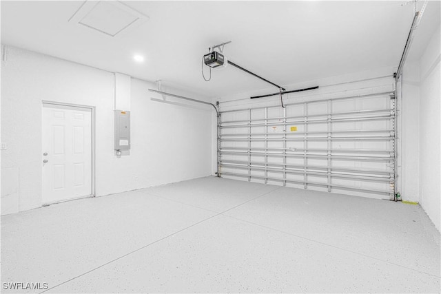 garage with a garage door opener and electric panel