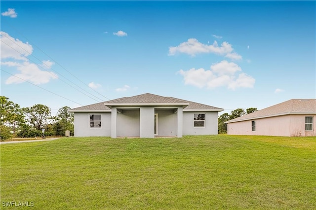 back of house with a lawn