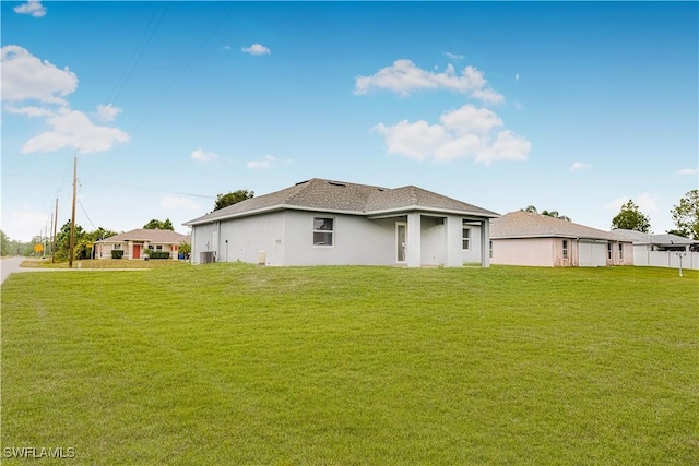 rear view of house with a yard