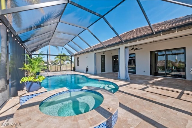 view of swimming pool with a lanai, a patio area, ceiling fan, and an in ground hot tub