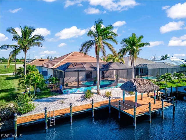 view of dock with a water view, a lanai, and a lawn