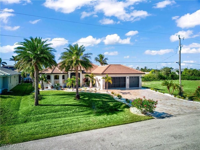 mediterranean / spanish-style home with a garage and a front yard