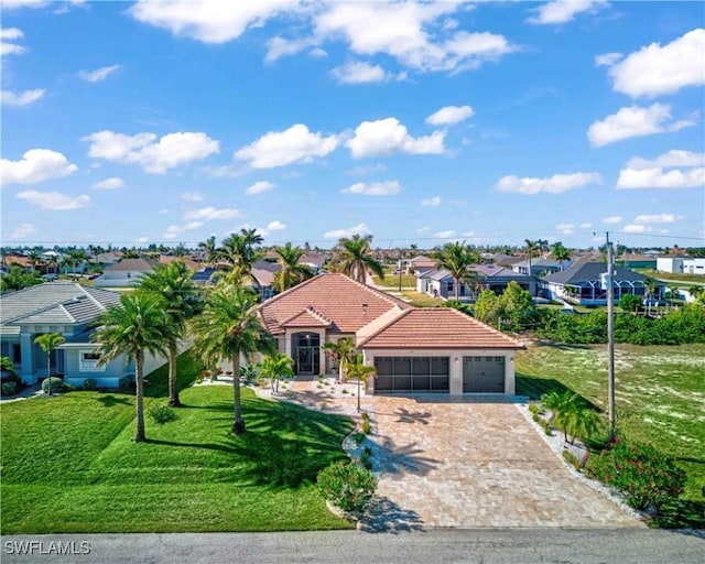 view of front of property featuring a garage and a front yard