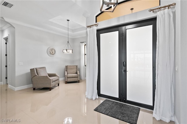 entryway featuring crown molding and a tray ceiling