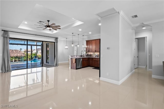 kitchen featuring decorative light fixtures, ornamental molding, and a raised ceiling