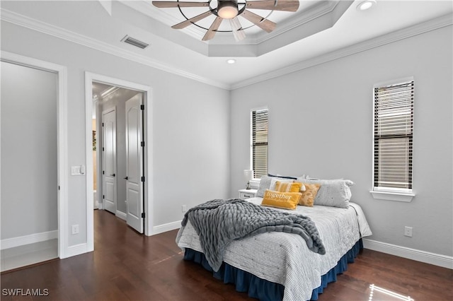 bedroom with a raised ceiling, crown molding, ceiling fan, and multiple windows