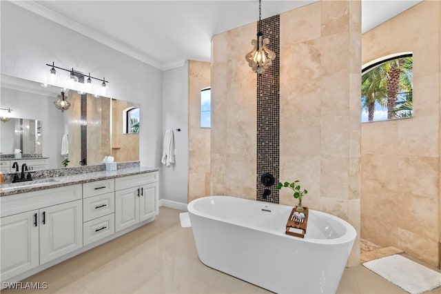 bathroom with a washtub, crown molding, tile patterned flooring, tile walls, and vanity