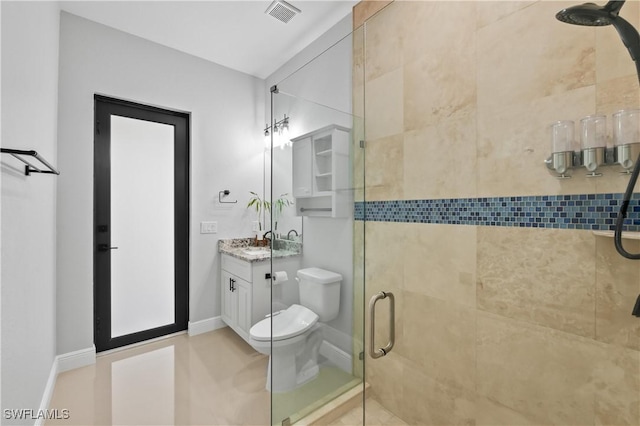 bathroom with vanity, toilet, and a shower with shower door