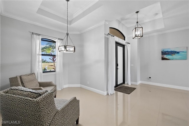 interior space featuring ornamental molding and a tray ceiling