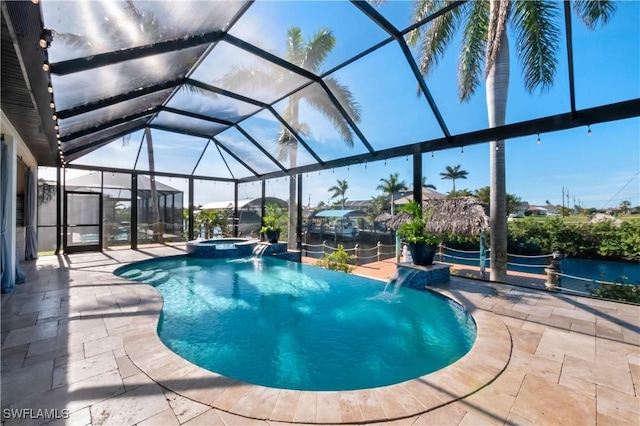 view of swimming pool featuring an in ground hot tub, pool water feature, glass enclosure, and a patio area